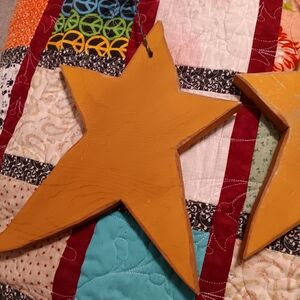 2 very sturdy wooden stars each unique with metal attached to hang new
